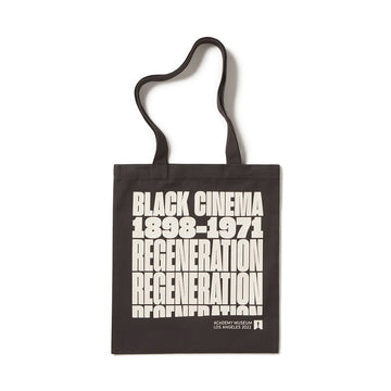 Black tote bag with white text on a white background Regneration Black Cineman Academy museum gallery exhibition exclusive official totebag
